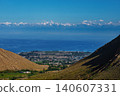 Picturesque view of lake Issyk-Kul and the Tien-Shan mountains from the mountain valley, Kyrgyzstan 140607331