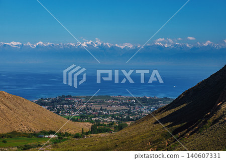 Picturesque view of lake Issyk-Kul and the Tien-Shan mountains from the mountain valley, Kyrgyzstan 140607331