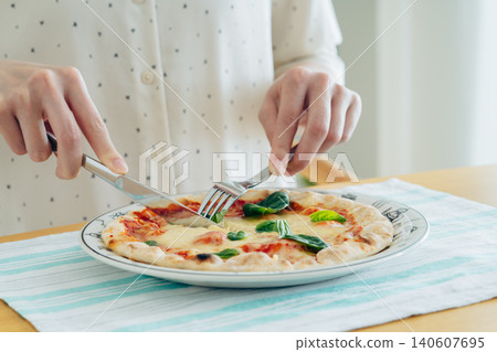 A young woman eating pizza at home A young woman eating pizza at home 140607695