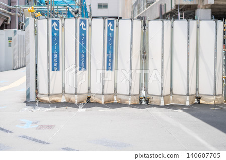 [Hamamatsucho] A view of station information signs posted on the retractable temporary fence at a redevelopment construction site. 140607705