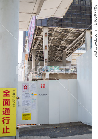 [Hamamatsucho] A road closure sign due to redevelopment work and a view of the steel frame structure of a building being demolished. 140607706