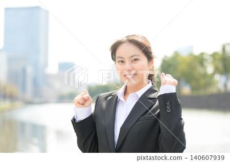 A Japanese woman in her 20s, working in an office, makes a victory pose. A Japanese woman in her 20s, working in an office, makes a victory pose. 140607939