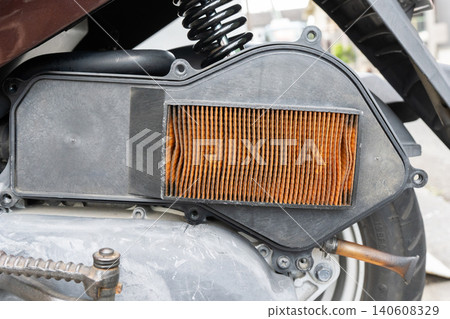 Replacing the air cleaner filter on a scooter and removing the box cover. 140608329