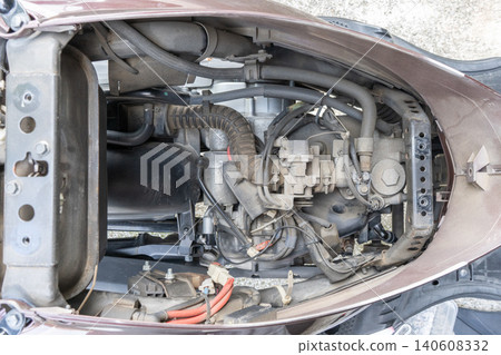 The entire interior of a 125cc scooter with the seat removed (filled with sand and dust). The entire interior of a 125cc scooter with the seat removed (filled with sand and dust). 140608332
