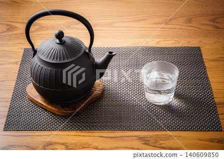 Still life photograph of an iron kettle and hot water. Still life photograph of an iron kettle and hot water. 140609850