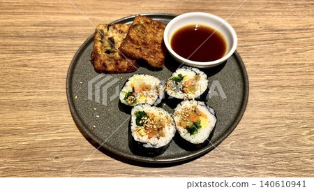 紫菜包飯和煎餅，是盛放在盤子裡的韓國料理。 140610941