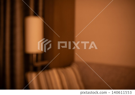 Blurred background image: Hotel room - simple and dimly lit interior Blurred background image: Hotel room - simple and dimly lit interior 140611553