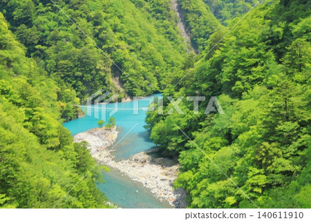 A view of the bluish river flowing from the beautiful dam lake in Sumatakyo Gorge. A view of the bluish river flowing from the beautiful dam lake in Sumatakyo Gorge. 140611910