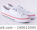 Pair of White Canvas Sneakers background 140612045