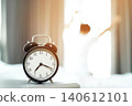 Alarm clock on table with falling piece of bread in bright kitchen 140612101