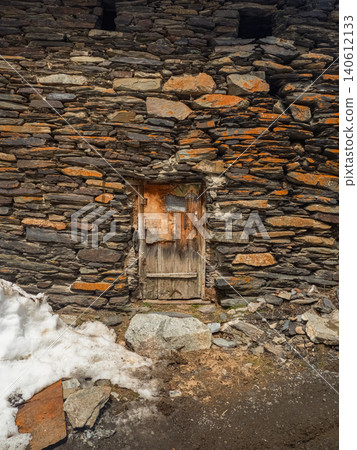 Old stone wall with weathered wooden door Old stone wall with weathered wooden door 140612133