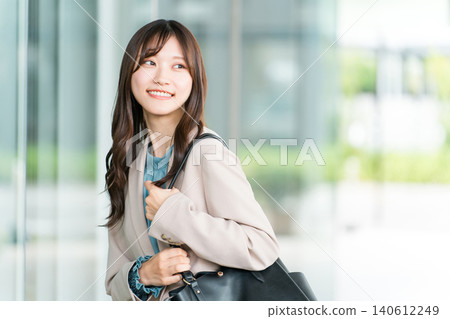 Young Asian businesswoman walking in an office area in the city Young Asian businesswoman walking in an office area in the city 140612249