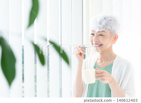 Senior woman brushing teeth Senior woman brushing teeth 140612403