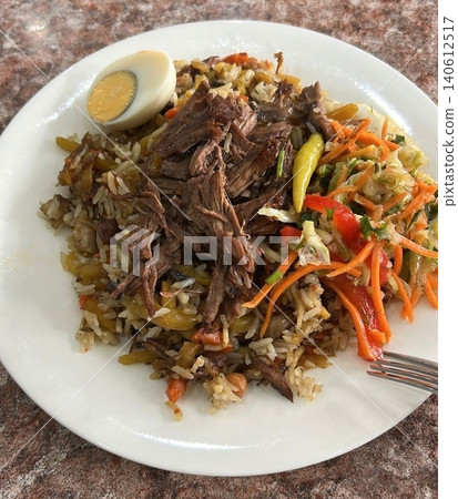 Traditional Rice Dish With Slow Cooked Meat And Fresh Salad Traditional Rice Dish With Slow Cooked Meat And Fresh Salad 140612517