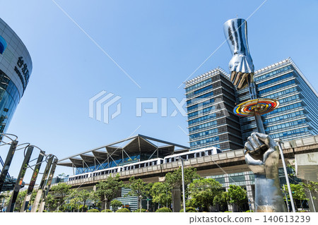 A train on the Wenhu or Brown Line of the Taipei MRT passes by the modern metropolis building in Nangang Software Park Area. A train on the Wenhu or Brown Line of the Taipei MRT passes by the modern metropolis building in Nangang Software Park Area. 140613239