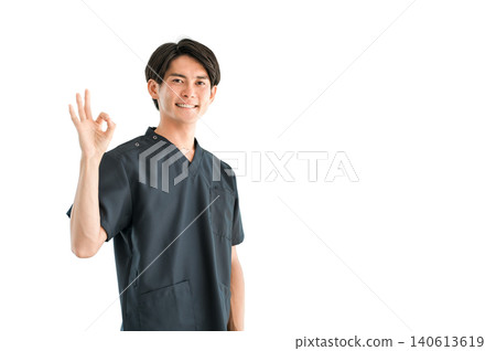 Young Asian male doctor, nurse, caregiver, and emergency physician wearing scrubs Young Asian male doctor, nurse, caregiver, and emergency physician wearing scrubs 140613619