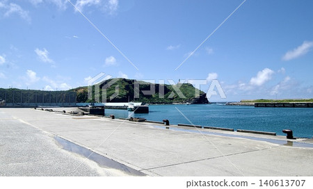 A view of hills and a blue sky with clouds from the pier of Kubura Port on Yonaguni Island. A view of hills and a blue sky with clouds from the pier of Kubura Port on Yonaguni Island. 140613707
