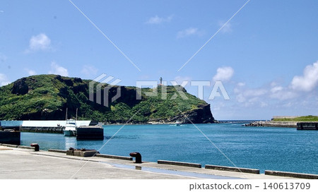 A view of hills and a blue sky with clouds from the pier of Kubura Port on Yonaguni Island. A view of hills and a blue sky with clouds from the pier of Kubura Port on Yonaguni Island. 140613709