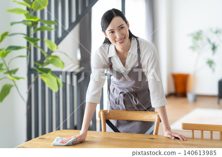 A housewife cleaning the dining table A housewife cleaning the dining table 140613985