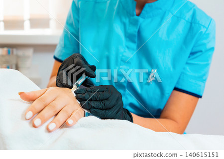 Procedure in beauty salon. Doctor makes injections of botulinum toxin on the client's hand against hyperhidrosis. Close up. Concept of skin care Procedure in beauty salon. Doctor makes injections of botulinum toxin on the client's hand against hyperhidrosis. Close up. Concept of skin care 140615151