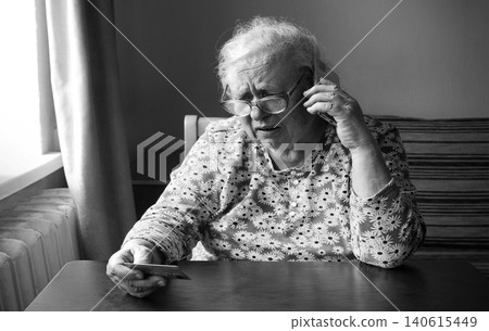 Old woman look at card Old woman look at card 140615449
