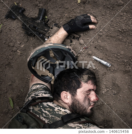 Wounded soldier laying on the ground Wounded soldier laying on the ground 140615456