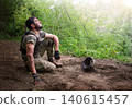 Young soldier sitting on the ground 140615457