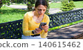 Young girl looking at phone 140615462