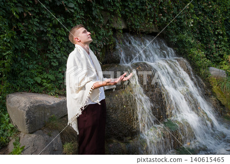 Young guy at old waterfall Young guy at old waterfall 140615465