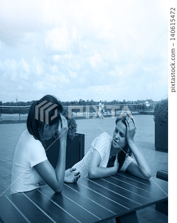 Young girls in a cafe Young girls in a cafe 140615472