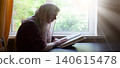 Young woman reading the old book 140615478