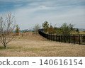 Snow-capped mountains visible in the distance of the spacious park. 140616154