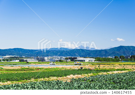 The rural landscape of Hata and the Yatsugatake mountain range visible in the distance. 140617455