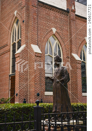 Bronze Statue in Front of Historic Red Brick Gothic Church Jackson Mississippi Bronze Statue in Front of Historic Red Brick Gothic Church Jackson Mississippi 140617721