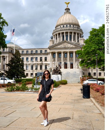 Female Tourist Standing in Front of Mississippi State Capitol Jackson MS 140617761