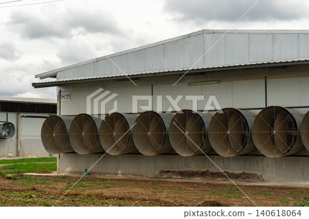Industrial Ventilation Fans on Modern Poultry Farm Building Exterior 140618064