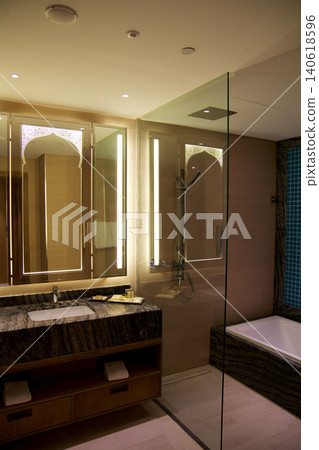 Al Marjan Island, United Arab Emirates, November 11 2017: Hotel bathroom with vanity and walk in shower with glass partition Al Marjan Island, United Arab Emirates, November 11 2017: Hotel bathroom with vanity and walk in shower with glass partition 140618596