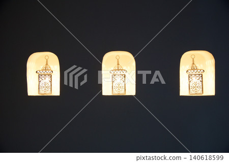 Fujairah, United Arab Emirates, November 04 2017: Three oriental wall lamps in decorative niches in luxury hotel 140618599