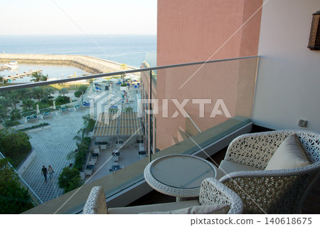 Fujairah, United Arab Emirates, November 04 2017: Balcony with wicker furniture and sea view in luxury hotel Fujairah, United Arab Emirates, November 04 2017: Balcony with wicker furniture and sea view in luxury hotel 140618675
