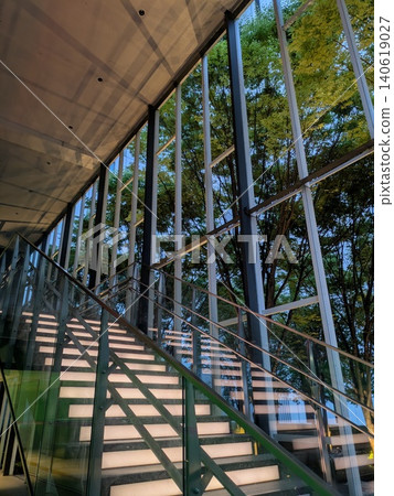 Beautiful fresh greenery and stairs reflected in the building Beautiful fresh greenery and stairs reflected in the building 140619027