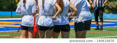 Group of Girls Huddle During a Flag Football Game Preparing for the Next Play Group of Girls Huddle During a Flag Football Game Preparing for the Next Play 140619876