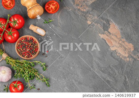 Tomatoes garlic thyme and spices on dark stone background with copy space Tomatoes garlic thyme and spices on dark stone background with copy space 140619937