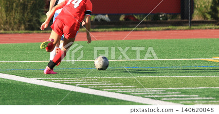 Soccer Player Runs Towards the Ball on a Turf Field During a Match Soccer Player Runs Towards the Ball on a Turf Field During a Match 140620048