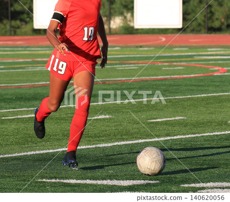 Soccer Player Runs With Ball on Field During Game Soccer Player Runs With Ball on Field During Game 140620056