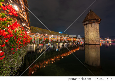 The Chapel Bridge and water tower, illuminated at night on the Reuss River. Lucerne, Canton of Lucerne, Switzerland. The Chapel Bridge and water tower, illuminated at night on the Reuss River. Lucerne, Canton of Lucerne, Switzerland. 140620307