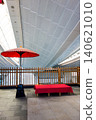 A red umbrella and chairs with red cloth covers in Edo-koji, Terminal 3 of Haneda Airport 140621010