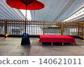 A red umbrella and chairs with red cloth covers in Edo-koji, Terminal 3 of Haneda Airport 140621011