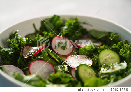 Summer fresh salad with radish, cucumber and herbs in white bowl Summer fresh salad with radish, cucumber and herbs in white bowl 140621388