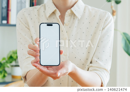 Young woman using a smartphone at home 140621474