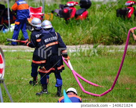 Firefighters conducting fire drills at the New Year's fire brigade parade. Firefighters conducting fire drills at the New Year's fire brigade parade. 140621824
